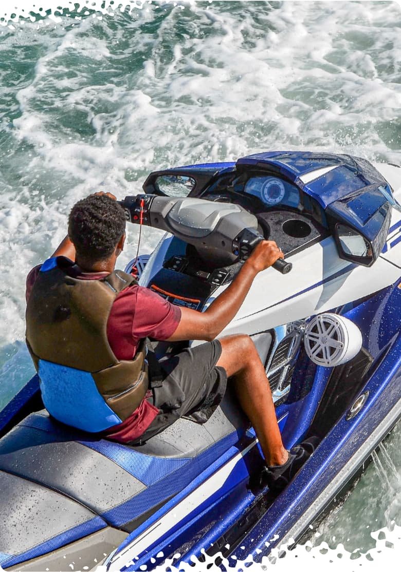 A man riding a blue jet ski enjoying the ocean.